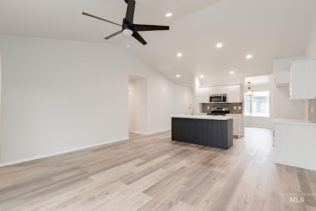 5315 E Burnte Peak St, Nampa, ID 83687 - kitchen featuring stainless steel appliances, white cabinetry, an island with sink, light countertops, and a ceiling fan