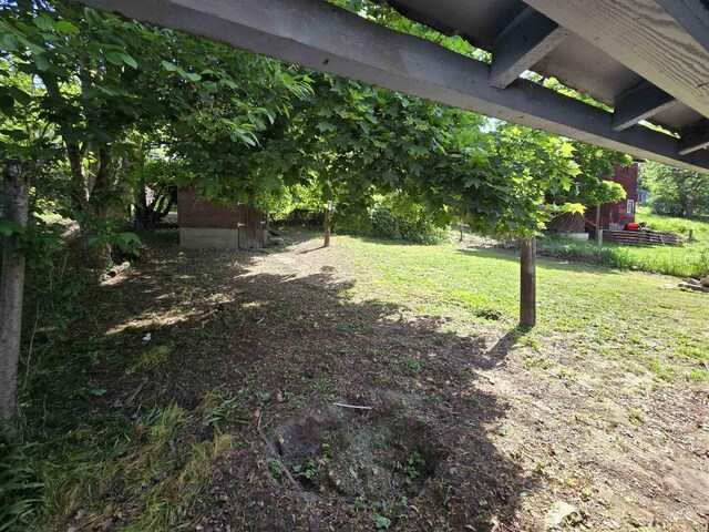 628 Main St, Orofino, ID 83544 - view of grassy yard with a storage shed and an outbuilding