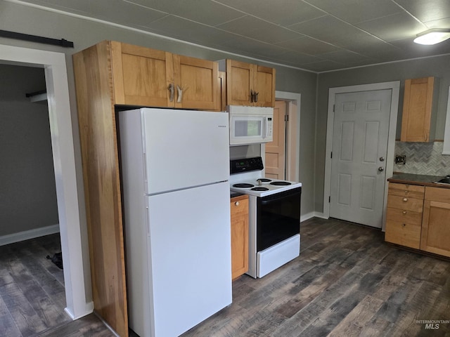628 Main St, Orofino, ID 83544 - kitchen with white appliances, dark wood-type flooring, tasteful backsplash, baseboards, and dark countertops