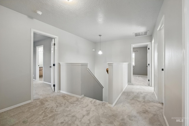 841 Shire St, Middleton, ID 83644 - hall with an upstairs landing, carpet floors, baseboards, and a textured ceiling
