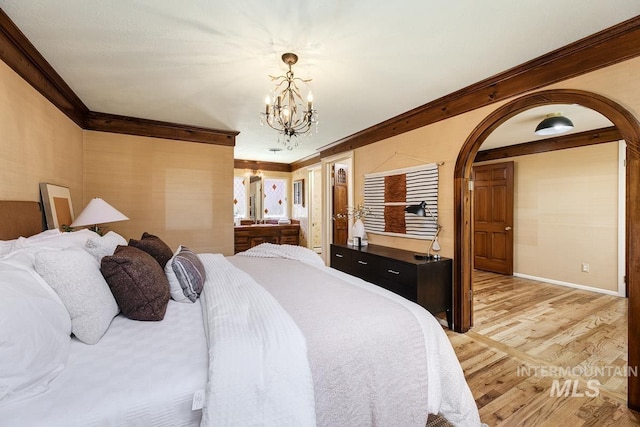 928 N Argyll Dr, Boise, ID 83702 - bedroom featuring crown molding, a chandelier, light wood finished floors, arched walkways, and baseboards