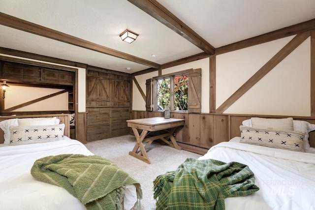 928 N Argyll Dr, Boise, ID 83702 - bedroom with beamed ceiling, light carpet, a wainscoted wall, and wooden walls