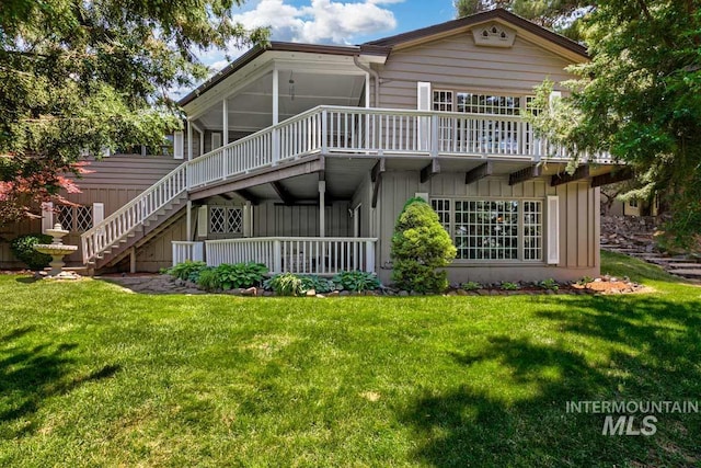 928 N Argyll Dr, Boise, ID 83702 - back of property with stairway, a lawn, and a sunroom