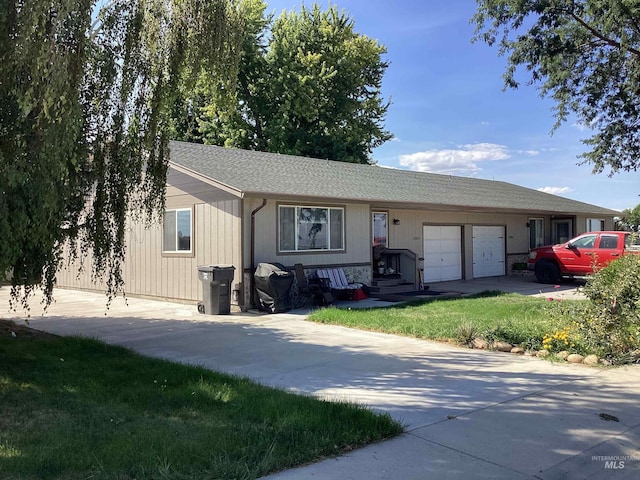 ranch-style house with a front yard and a garage