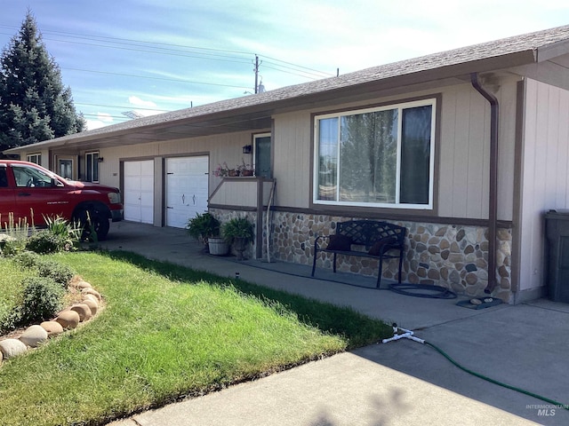 ranch-style house with a front lawn and a garage