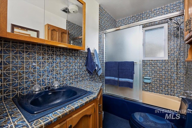 371 Dubois, Twin Falls, ID 83301 - full bathroom with vanity, decorative backsplash, and shower / bath combination with glass door