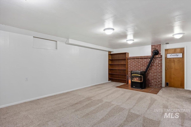 371 Dubois, Twin Falls, ID 83301 - finished below grade area featuring visible vents, baseboards, carpet, and a wood stove