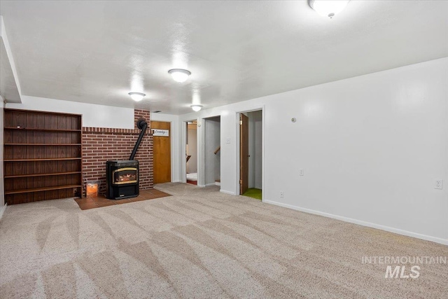 371 Dubois, Twin Falls, ID 83301 - unfurnished living room with stairway, baseboards, a wood stove, and carpet flooring