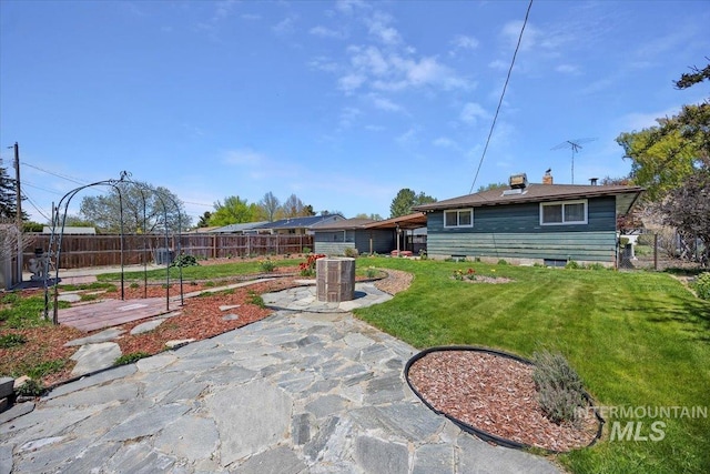 371 Dubois, Twin Falls, ID 83301 - back of property featuring a patio, fence, a yard, and a chimney