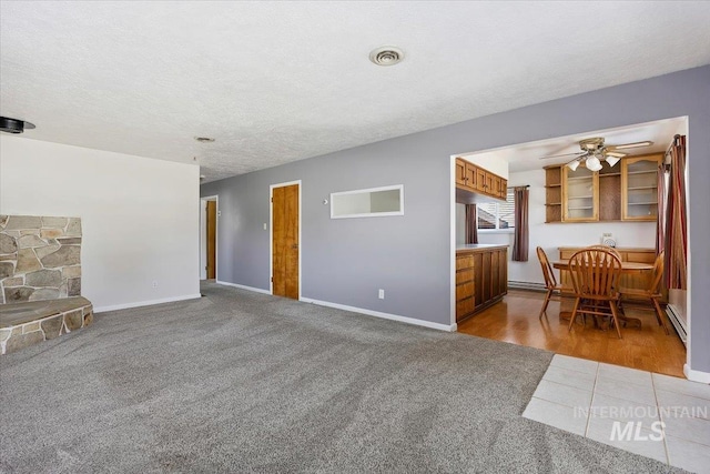 371 Dubois, Twin Falls, ID 83301 - living area with visible vents, carpet flooring, baseboards, and a baseboard radiator