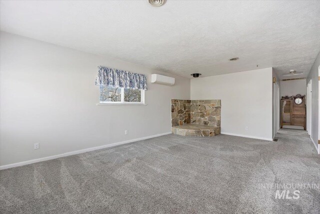 371 Dubois, Twin Falls, ID 83301 - unfurnished living room featuring baseboards, carpet flooring, a textured ceiling, and a wall unit AC