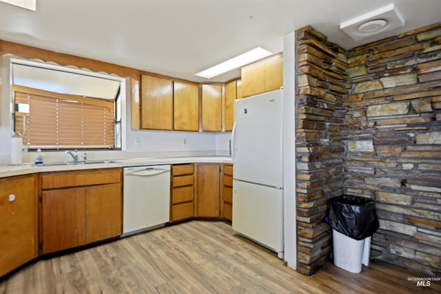 kitchen with sink, white appliances, and light hardwood / wood-style flooring