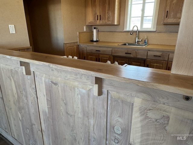 kitchen featuring light countertops and a sink