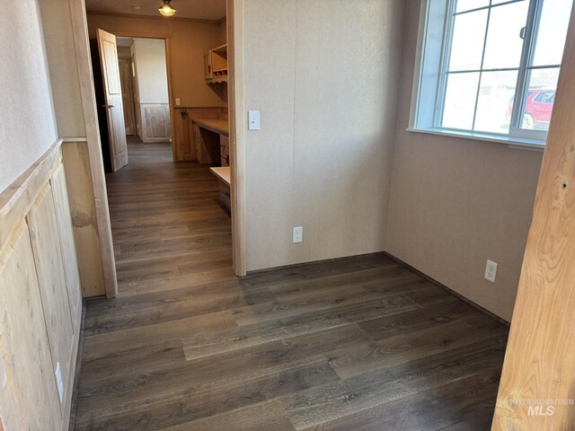 corridor featuring dark wood-style flooring