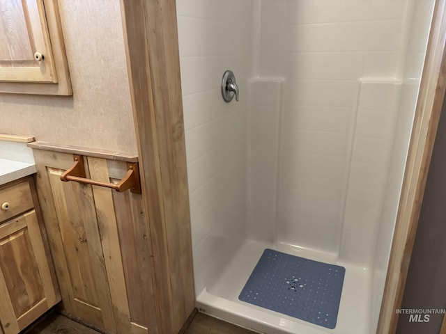 full bathroom featuring a stall shower and vanity