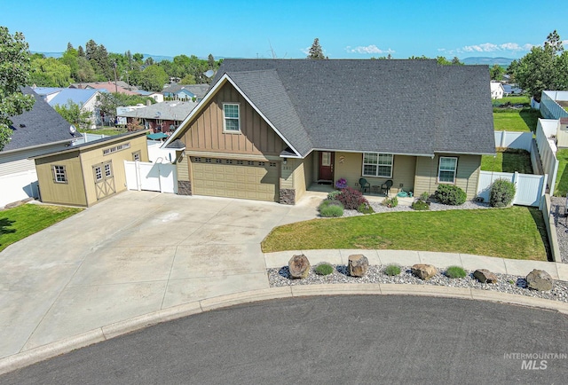 201 E S 10th St, Grangeville, ID 83530 - view of front of house featuring board and batten siding, concrete driveway, an attached garage, a shingled roof, and covered porch