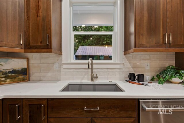 kitchen with dishwasher, tasteful backsplash, and sink