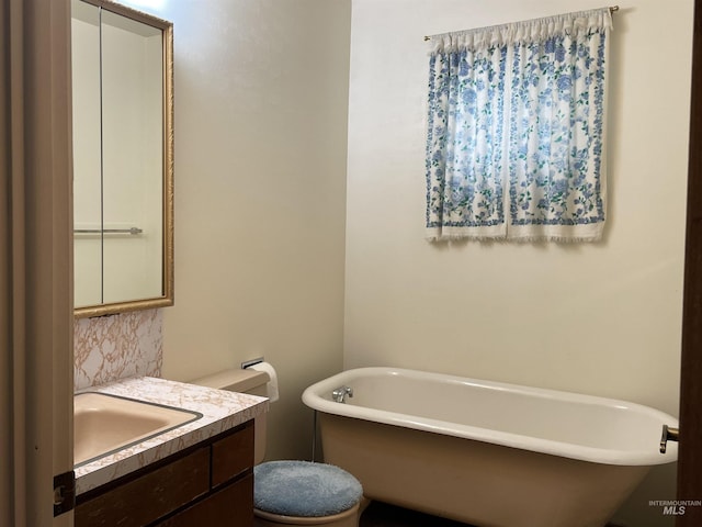 410 3rd Ave E, Jerome, ID 83338 - full bathroom featuring decorative backsplash, a freestanding tub, vanity, and toilet