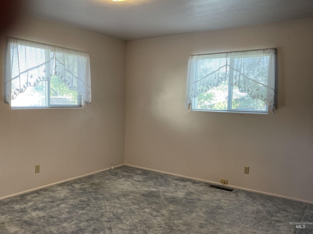 410 3rd Ave E, Jerome, ID 83338 - empty room with healthy amount of natural light, carpet flooring, and baseboards