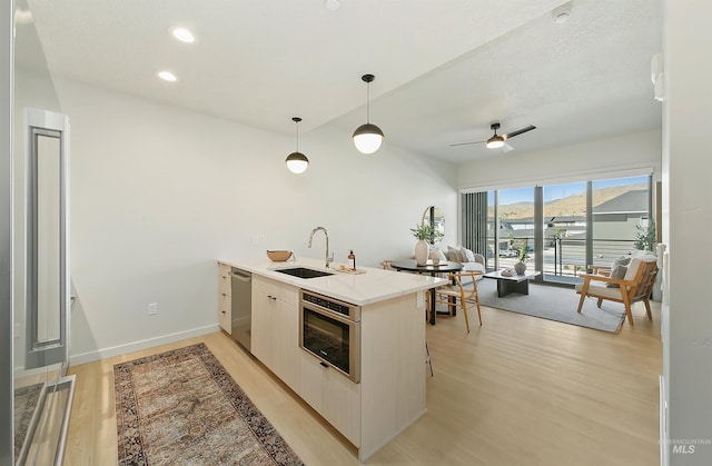 4340 E Haystack St Unit 205, Boise, ID 83716 - kitchen with a peninsula, dishwasher, light wood-style floors, pendant lighting, and recessed lighting