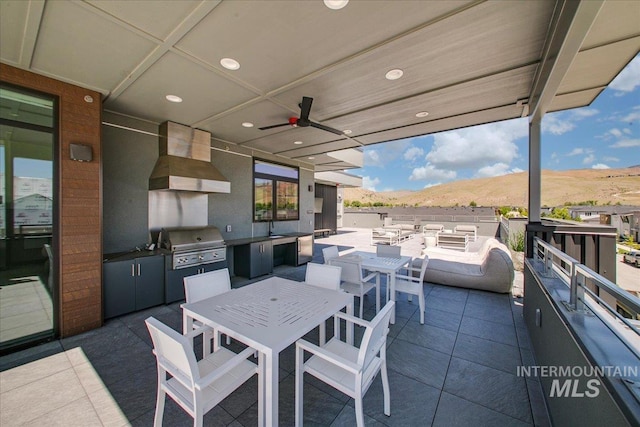 4340 E Haystack St Unit 205, Boise, ID 83716 - view of patio with exterior kitchen, outdoor dining area, outdoor lounge area, a mountain view, and ceiling fan