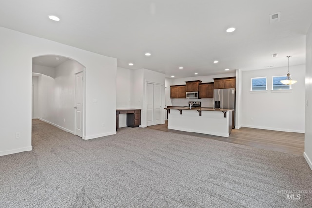 unfurnished living room featuring carpet floors