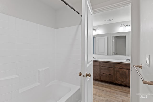 bathroom with vanity, hardwood / wood-style flooring, and tub / shower combination