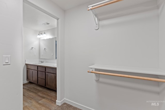 bathroom with vanity and hardwood / wood-style flooring