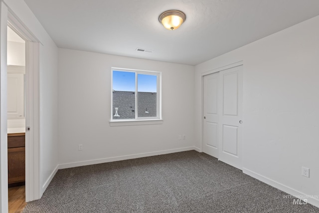 unfurnished bedroom featuring a closet and carpet floors