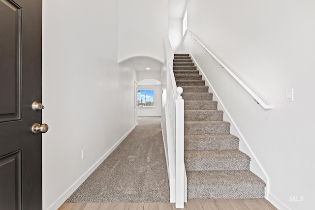 stairs with wood-type flooring