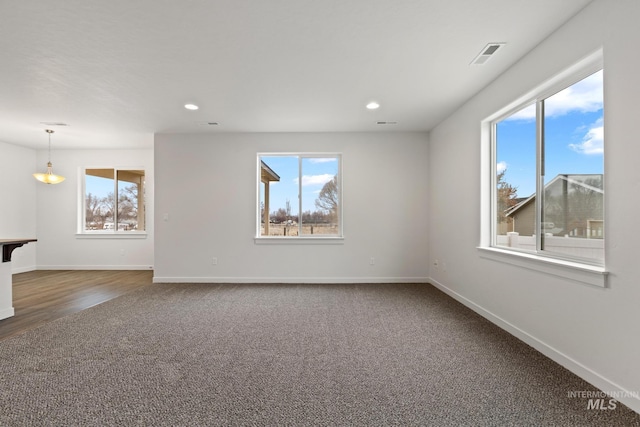 carpeted spare room with plenty of natural light