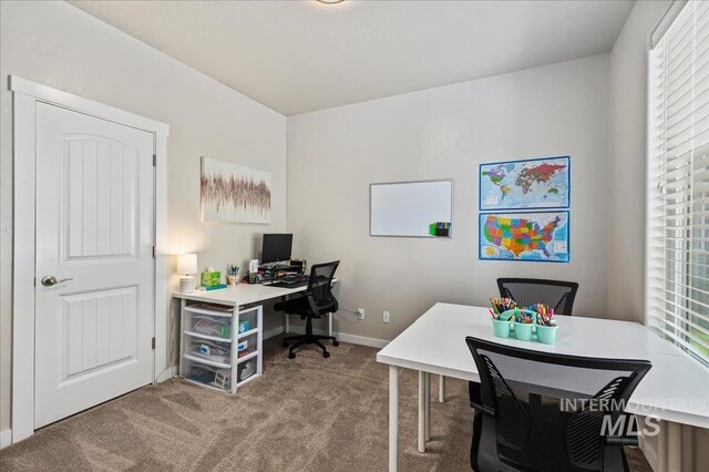carpeted office space featuring baseboards