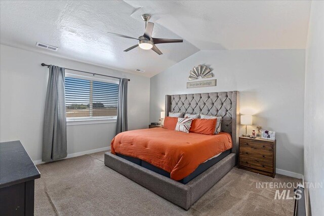carpeted bedroom with visible vents, baseboards, ceiling fan, and lofted ceiling