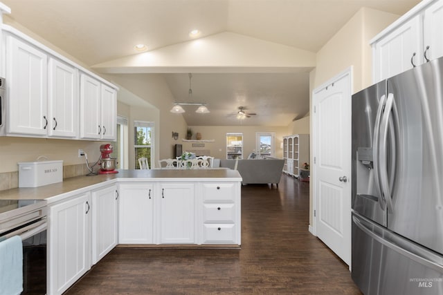 2493 S Skyview Dr, Nampa, ID 83686 - kitchen featuring stainless steel fridge, lofted ceiling, a peninsula, range with electric cooktop, and dark wood-type flooring