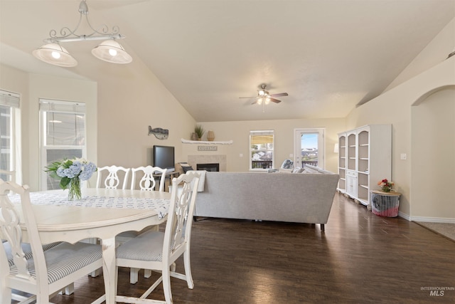 2493 S Skyview Dr, Nampa, ID 83686 - dining space featuring vaulted ceiling, a ceiling fan, dark wood finished floors, and a tiled fireplace