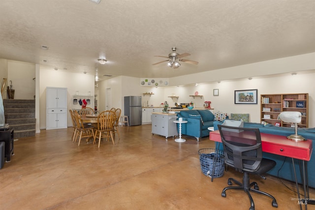 2493 S Skyview Dr, Nampa, ID 83686 - living area featuring concrete floors, ceiling fan, a textured ceiling, and stairs