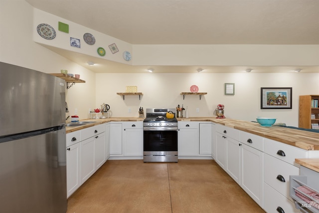 2493 S Skyview Dr, Nampa, ID 83686 - kitchen featuring appliances with stainless steel finishes, wooden counters, finished concrete flooring, white cabinetry, and a peninsula