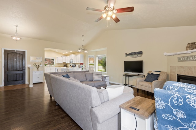 2493 S Skyview Dr, Nampa, ID 83686 - living room with lofted ceiling, dark wood finished floors, a ceiling fan, and a tiled fireplace