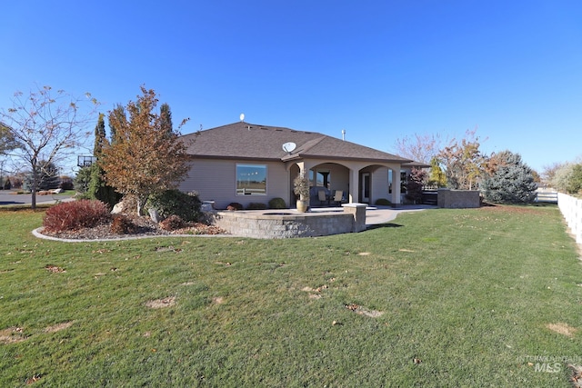 back of house with a yard and a patio area