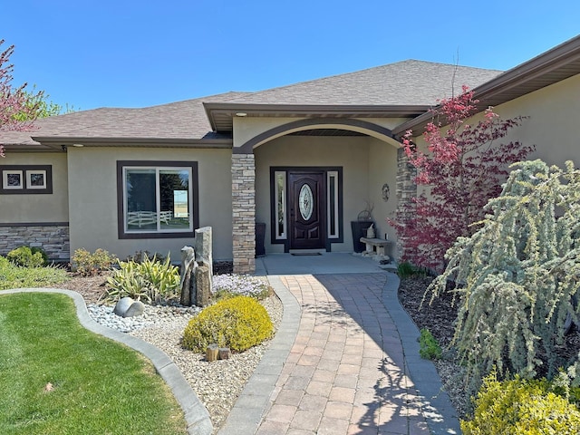924 Main St S, Kimberly, ID 83341 - entrance to property featuring stucco siding, stone siding, a shingled roof, and a porch