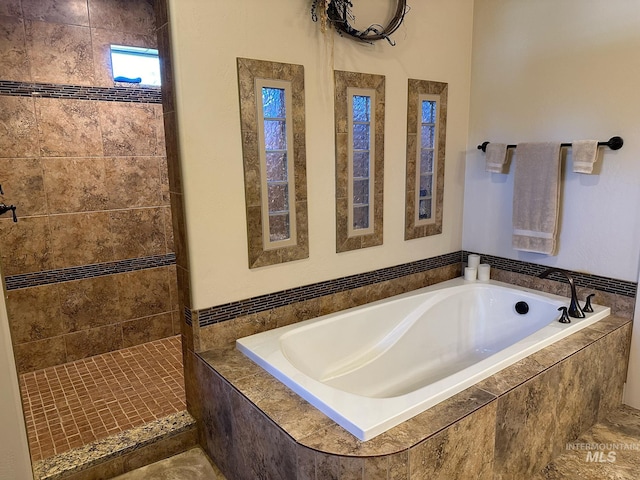 bathroom featuring plus walk in shower