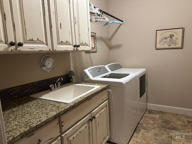 washroom featuring cabinets, separate washer and dryer, and sink