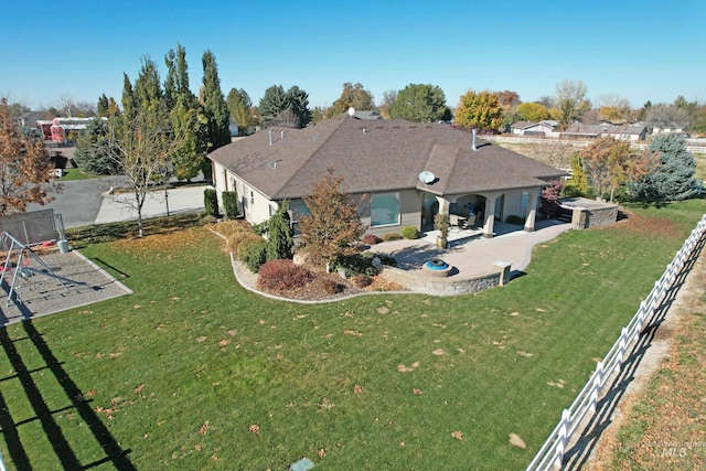 back of house featuring a yard and a patio area