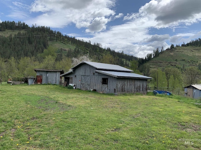 120 Three Bear Ln, Stites, ID 83552 - view of barn featuring a lawn, a mountain view, and a wooded view