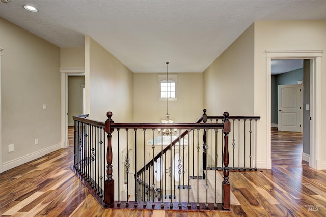 hallway with hardwood / wood-style flooring