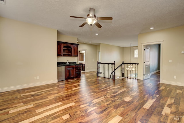 living room featuring sink, a textured ceiling, ceiling fan, and dark hardwood / wood-style floors