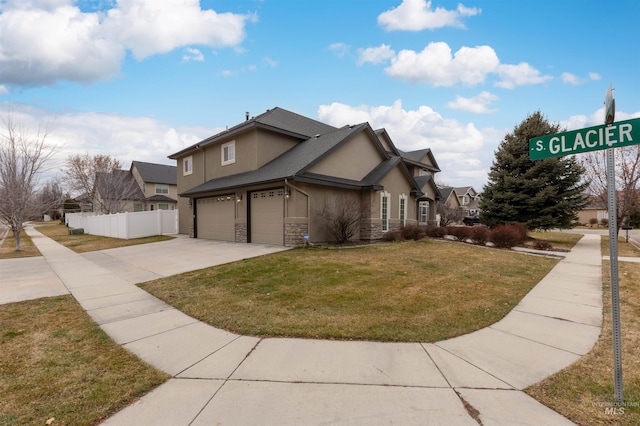 view of side of property featuring a yard and a garage