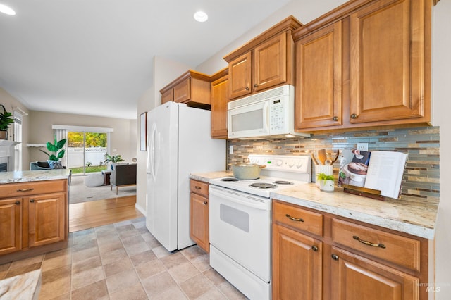 kitchen with white appliances, light stone counters, tasteful backsplash, and light tile patterned floors