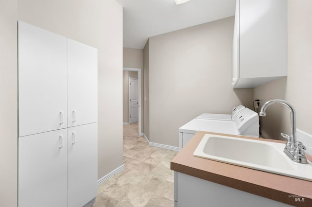 laundry room with sink and cabinets