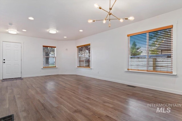 511 N 10th Ave N, Nampa, ID 83687 - unfurnished room with plenty of natural light, a chandelier, wood finished floors, and recessed lighting